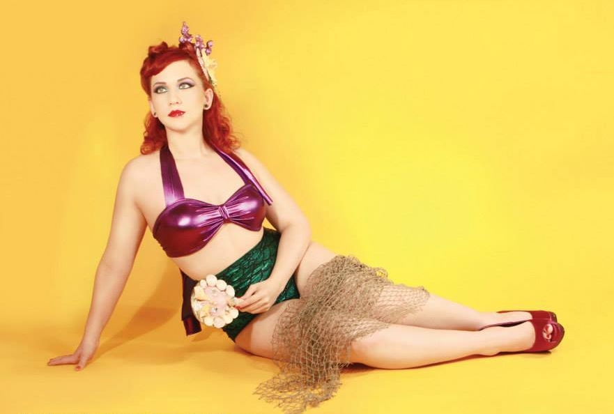 Redhead Pin Up Girl with Bare Legs wearing Purple Latex Bra